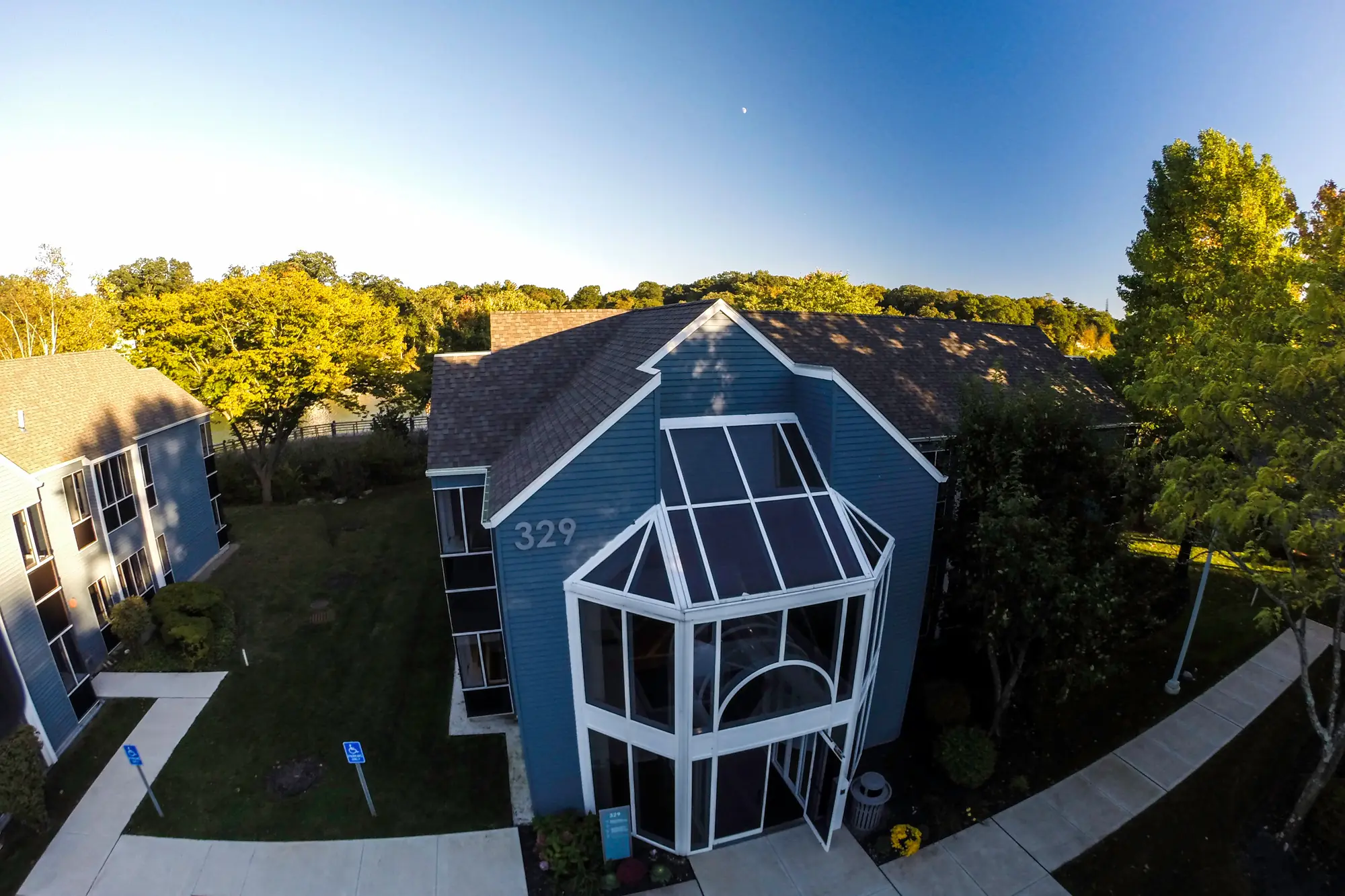 329 Riverside Avenue, the blue clapboard building Westport Dental Associates has occupied since 1963, seen from the air at golden hour.